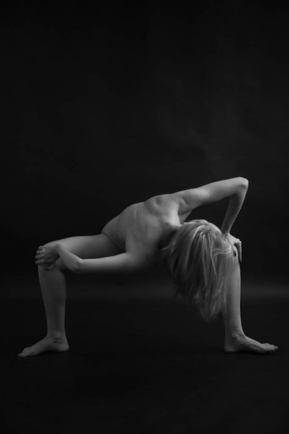 Naked woman body on black background. Fine art photo of female body. - Photo, image