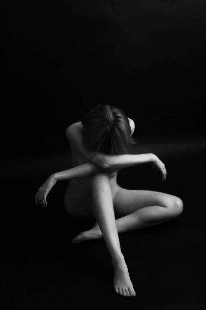 Naked woman body on black background. Fine art photo of female body. - Fotoğraf, Görsel