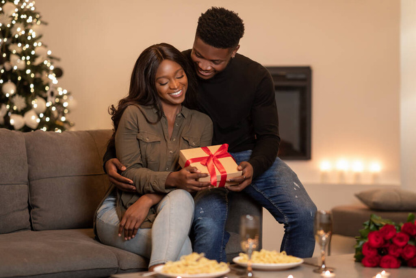 Black Boyfriend Embracing Girlfriend Giving Present On Valentines Day Indoor - Valokuva, kuva