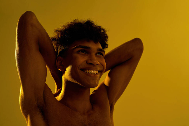 Black smiling sportsman stretching and looking up - Fotó, kép