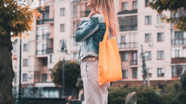 Young beautiful woman with linen eco bag on city background. - Fotoğraf, Görsel
