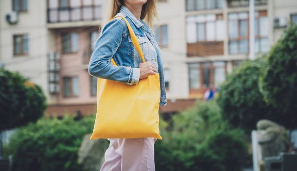 Young beautiful woman with linen eco bag on city background. - Fotografie, Obrázek