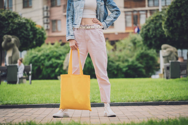 Young beautiful woman with linen eco bag on city background. - Photo, Image