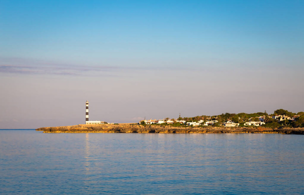 MINORCA ISLE - SPAIN - CIRCA AUGUST 2020: scenic Artrutx Lighthouse at sunset, famous landmark of the Isle - Photo, Image