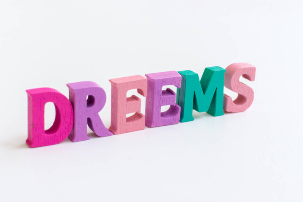 Dreams! The inscription from multi-colored letters on a white background. Beautiful card. Hand drawing, design elements. Shallow depth of field. - Foto, Bild