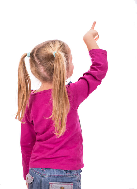 girl pointing up. Isolated on white background. - Фото, изображение