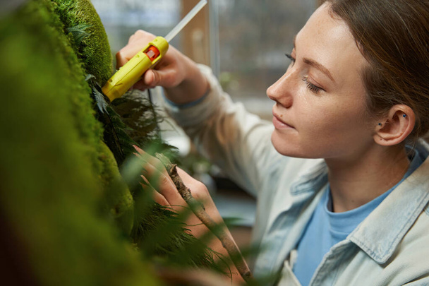 Young lady making picture with green plants - Foto, Imagen