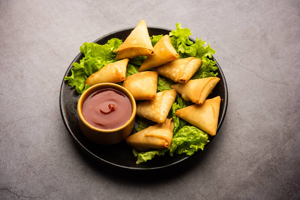 cocktail mini triangle samosa made using patti or strip, popular home made snack from India - Photo, Image
