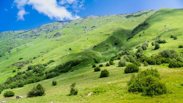 Photo Mountains of North Ossetia, beautiful summer landscapes with blue sky and clouds. - 写真・画像