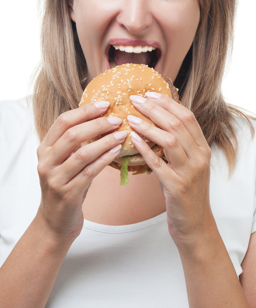 girl eating burger on white background - Foto, Imagen