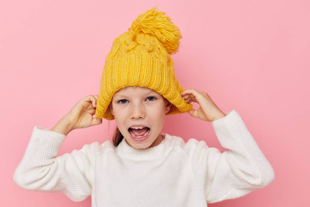 pretty young girl in a sweater and a hat isolated background - 写真・画像