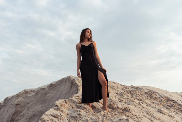 Tanned brunette in the sand dunes - Fotó, kép