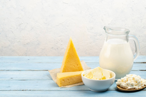 dairy products, cheese, butter, cottage cheese, milk on the table with white background, space for text - Foto, imagen
