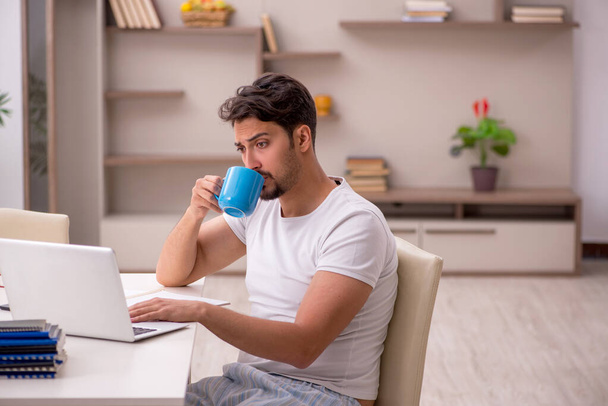Young male employee working from home during pandemic - Photo, Image