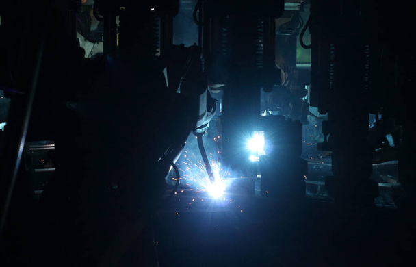 welding robot in the automotive parts industry, The movement of the robot welding in  auto parts factory. - Fotografie, Obrázek