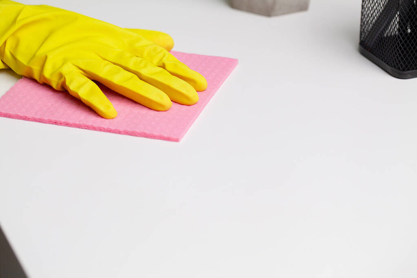 Young worker cleaning table with rag in office - Photo, image