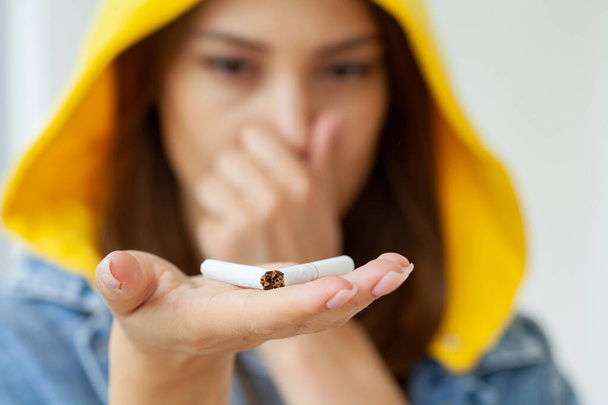 Young woman with broken cigarette, stop smoking concept. - Valokuva, kuva
