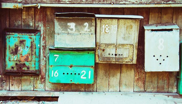 Old memory mailboxes concept. Multicolored old shabby mailboxes  - Photo, Image