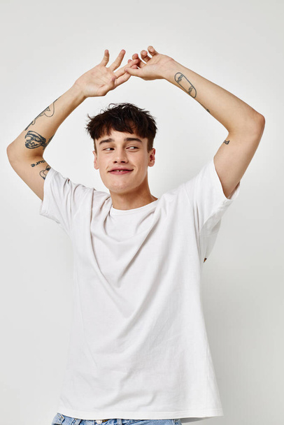 Man modern youth style white t-shirt tattoo on the arm Lifestyle unaltered - Valokuva, kuva