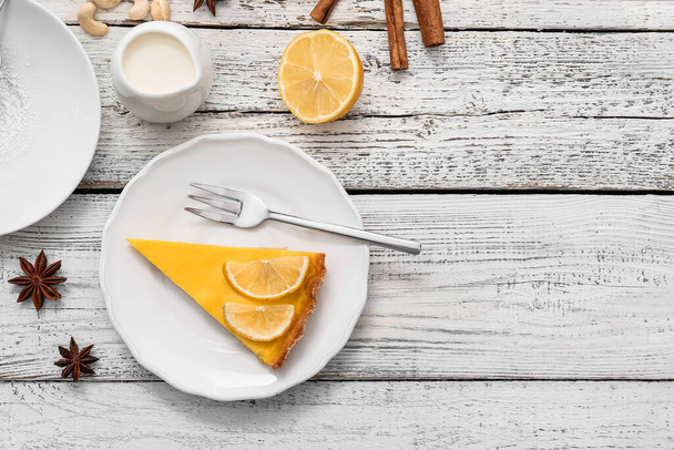 Plate with slice of tasty lemon tart on table - Photo, Image