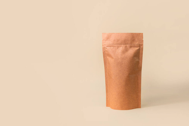 Pouch bag mockup neutral beige background monochrome. Merchandise packaging Blank brown kraft paper pack coffee beans product template copy space. Tea food snack delivery Shop store sale demonstration - 写真・画像