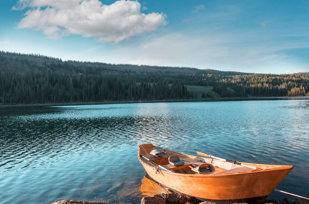 Boat on a beautiful mountains lake - Fotó, kép