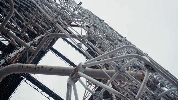 bottom view of old radio tower in chernobyl zone against grey sky - Photo, Image