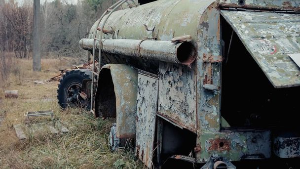 damaged and rusty military vehicle in forest in chernobyl exclusion zone - Photo, Image