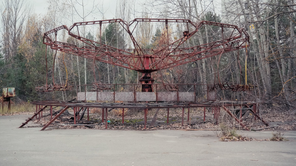 old carousel in amusement park in chernobyl abandoned city - Foto, imagen