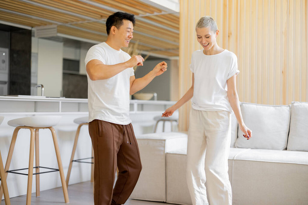 Multiracial couple dancing while resting at home - Foto, immagini
