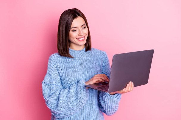 Portrait of attractive skilled cheery girl using laptop texting preparing report isolated over pink pastel color background. - Fotografie, Obrázek