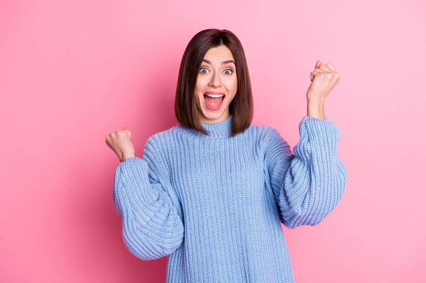 Portrait of attractive lucky crazy cheerful brown-haired girl having fun bargain isolated over pink pastel color background. - Foto, Imagem