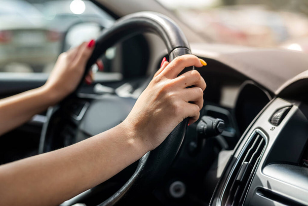 female hand holding steering wheel. Close-up. Travel concept   - Foto, Bild