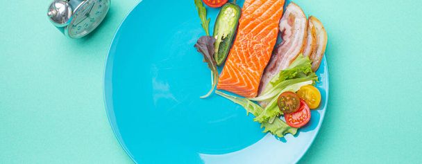 Intermittent fasting low carb hight fats diet concept flat lay, healthy food on blue plate - 写真・画像