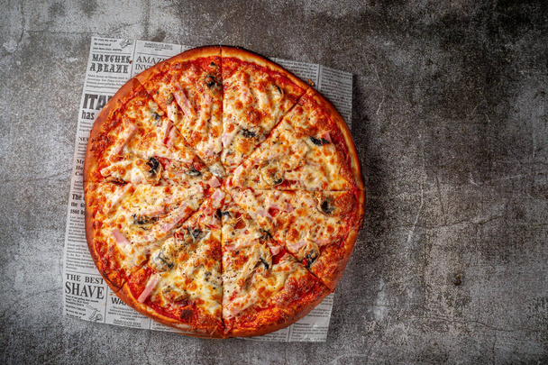 Fresh delicious Italian pizza on a gray stone table background - Foto, Imagen