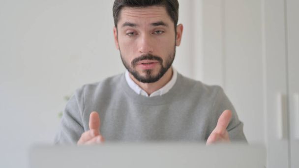 Close up of Young Man Talking on Video Call on Laptop - Photo, image