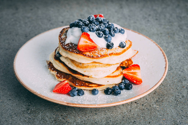 pancakes with berries and honey on a plate - Valokuva, kuva