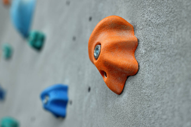 Climbing wall with holds in gym, closeup - Фото, зображення