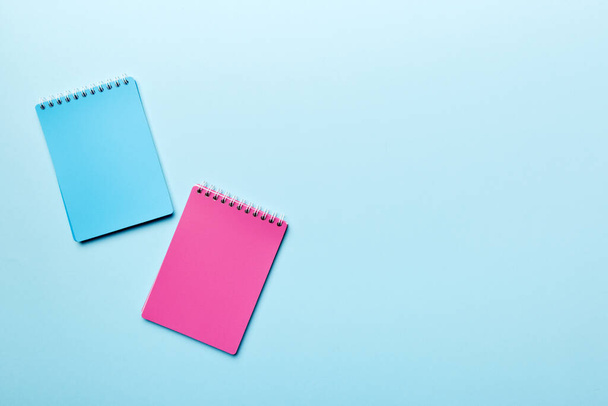 two school colored notebook on a desk background, spiral craft notepad on a table Top view. - Foto, afbeelding