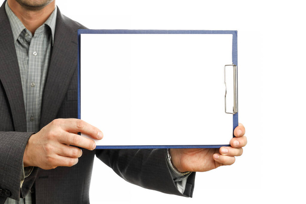 Businessman in suit holds clipboard and shows on it mockup, place for text and presentation, isolated on white background close-up - Fotó, kép