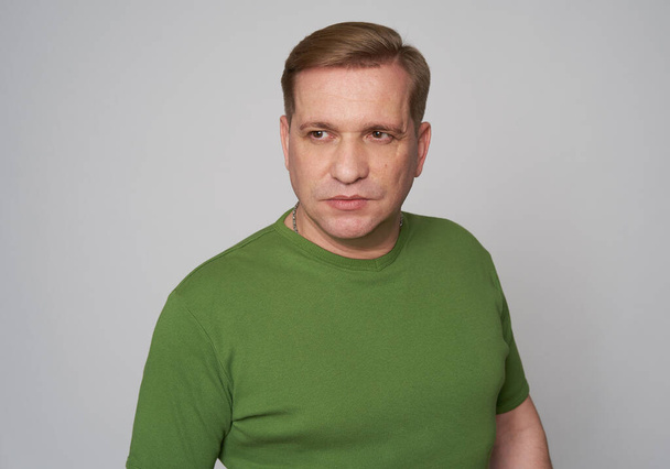 Studio portrait of a middle aged handsome male in green t-shirt - Foto, Imagem