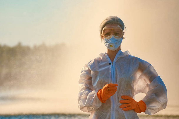 checking the water by a specialist in a protective suit and mask - Fotografie, Obrázek