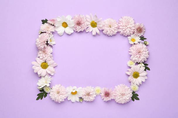 Frame made of beautiful chrysanthemum flowers on violet background, flat lay. Space for text - Photo, image