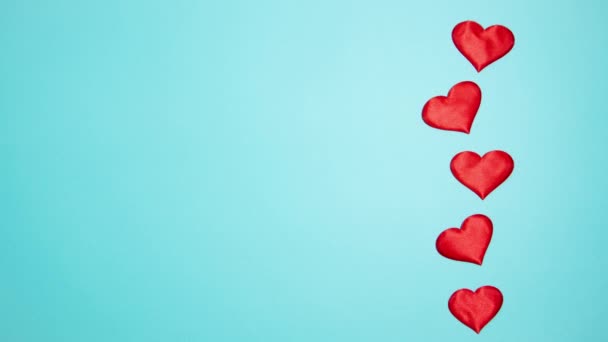 Red hearts on a blue background. Valentine's day concept. Stop motion animation. - Filmagem, Vídeo