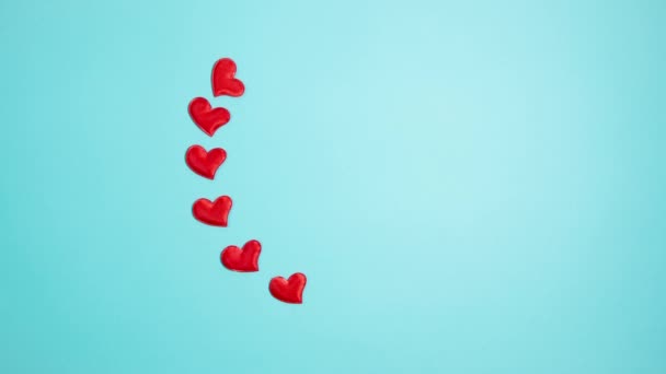 Red hearts on a blue background. Valentine's day concept. Stop motion animation. - Кадры, видео