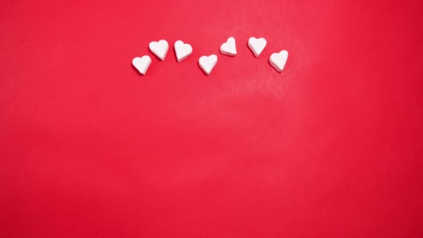 Heart made of sweet marshmallows on a red background. Valentine's day concept. - Záběry, video