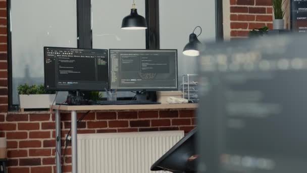 Desk with multiple computer monitors displaying parsing code and programming language compiling - Filmagem, Vídeo