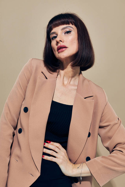 beautiful woman in a beige jacket elegant style posing light background - Fotografie, Obrázek