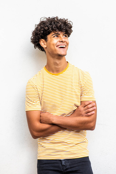 Portrait happy teenage boy with arms crossed and looking up - Photo, image