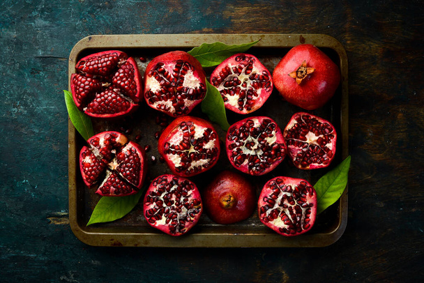 Fresh pomegranate fruits on a metal tray. Top view. Free space for your text. - Valokuva, kuva